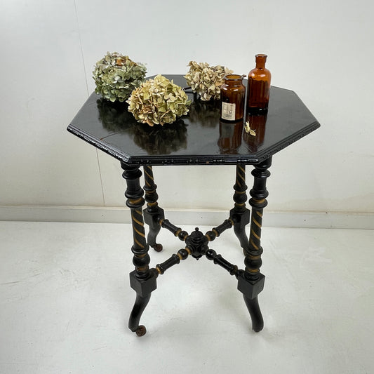 EBONISED SIDE TABLE ON CASTORS