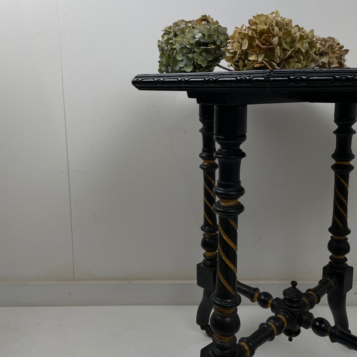 EBONISED SIDE TABLE ON CASTORS