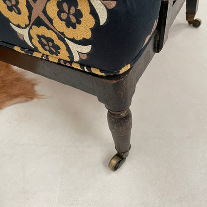 ANTIQUE BLACK EBONISED LIBRARY CHAIR ON CASTORS