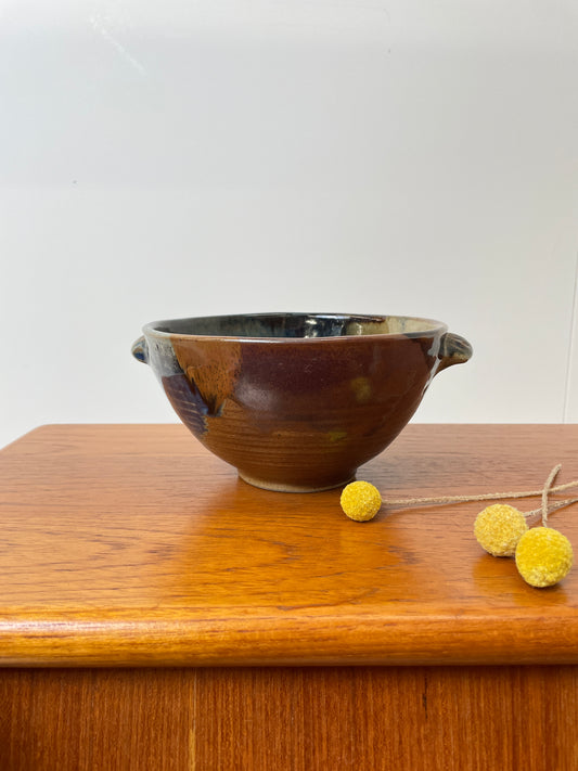 Studio Pottery Bowl In Muted Tones Brown, Clay, Beige & green, on top of a Teak Table with dried flowers