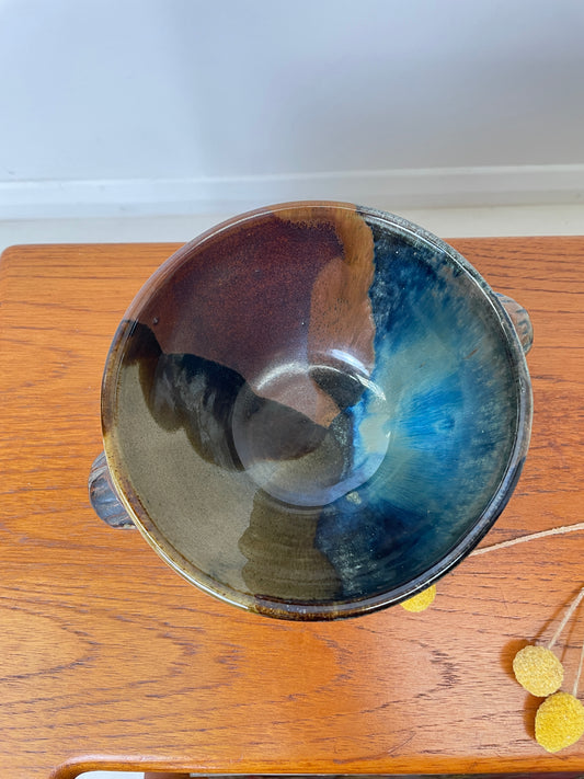 Studio Pottery Bowl In Muted Tones, top and inside of the bowl, showing its side handles and beauty, the bowl is in colours of blue, brown, green & beige with a finished glaze.
