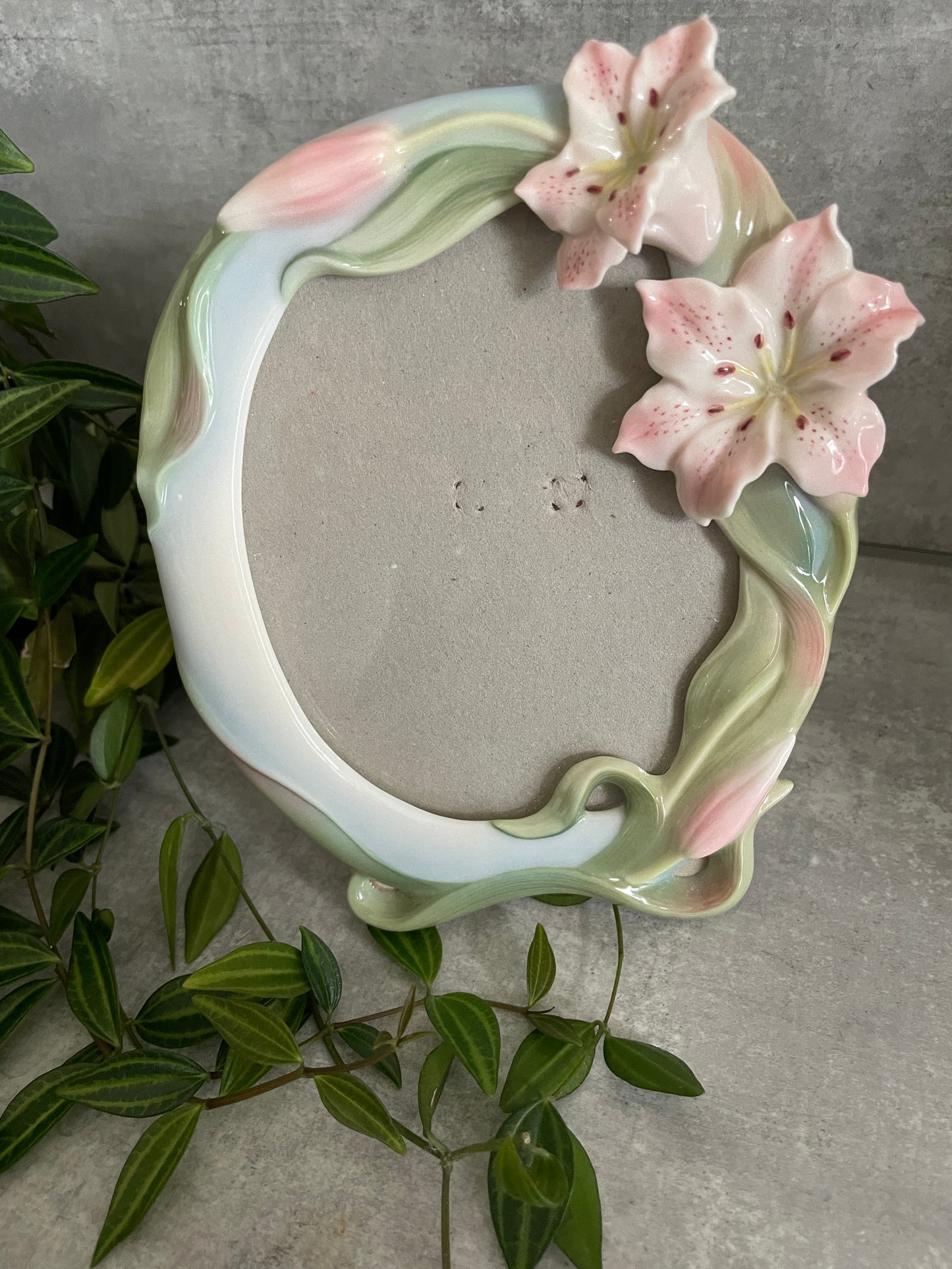 VINTAGE FRANZ PORCELAIN LILY PICTURE FRAME - with two oriental pink & white Lillies in the top corner of the frame, their green leaves trailing around the sides of the frame with two extra lillies about to bloom. 