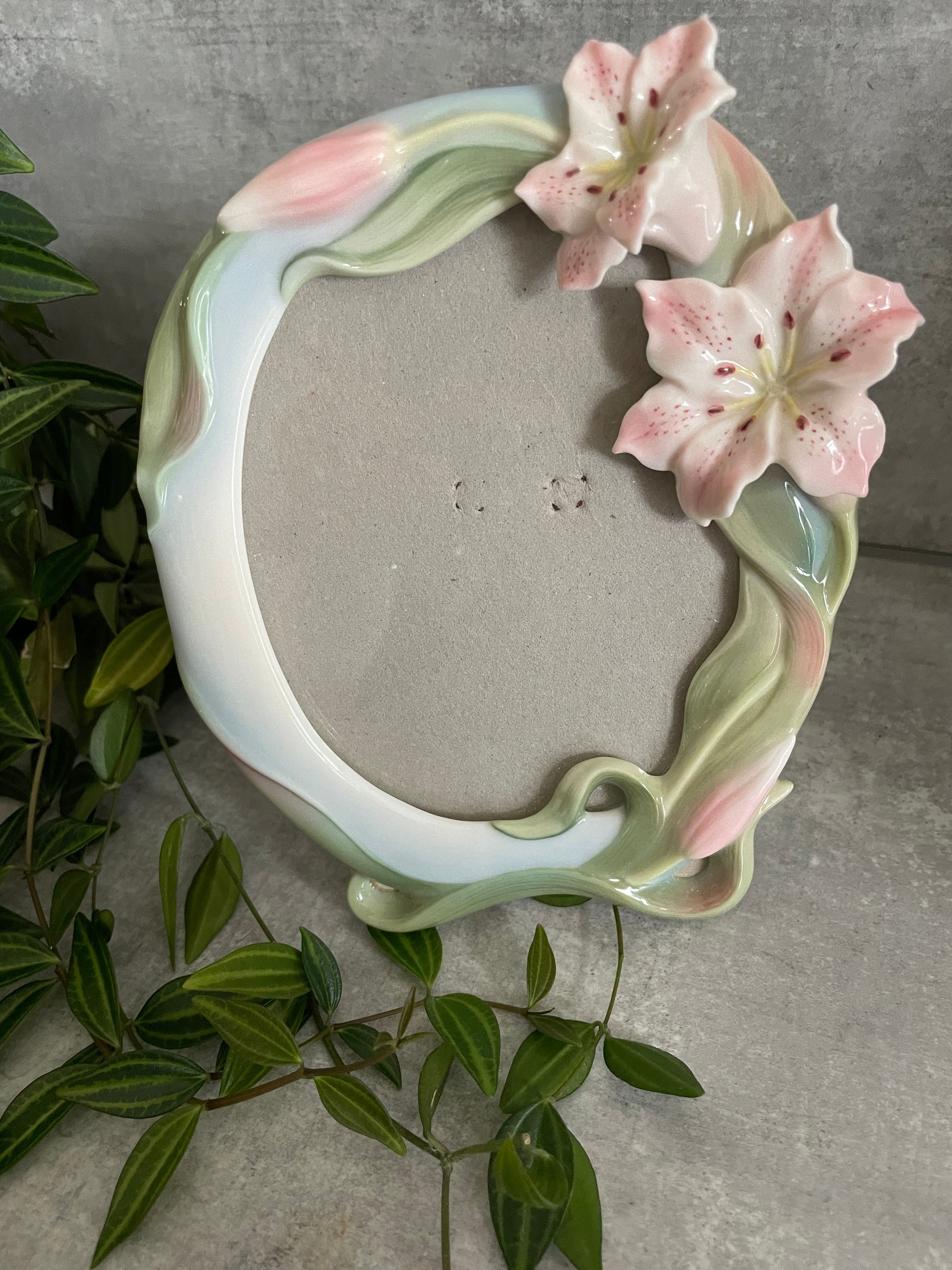 VINTAGE FRANZ PORCELAIN LILY PICTURE FRAME - with two oriental pink & white Lillies in the top corner of the frame, their green leaves trailing around the sides of the frame with two extra lillies about to bloom. 